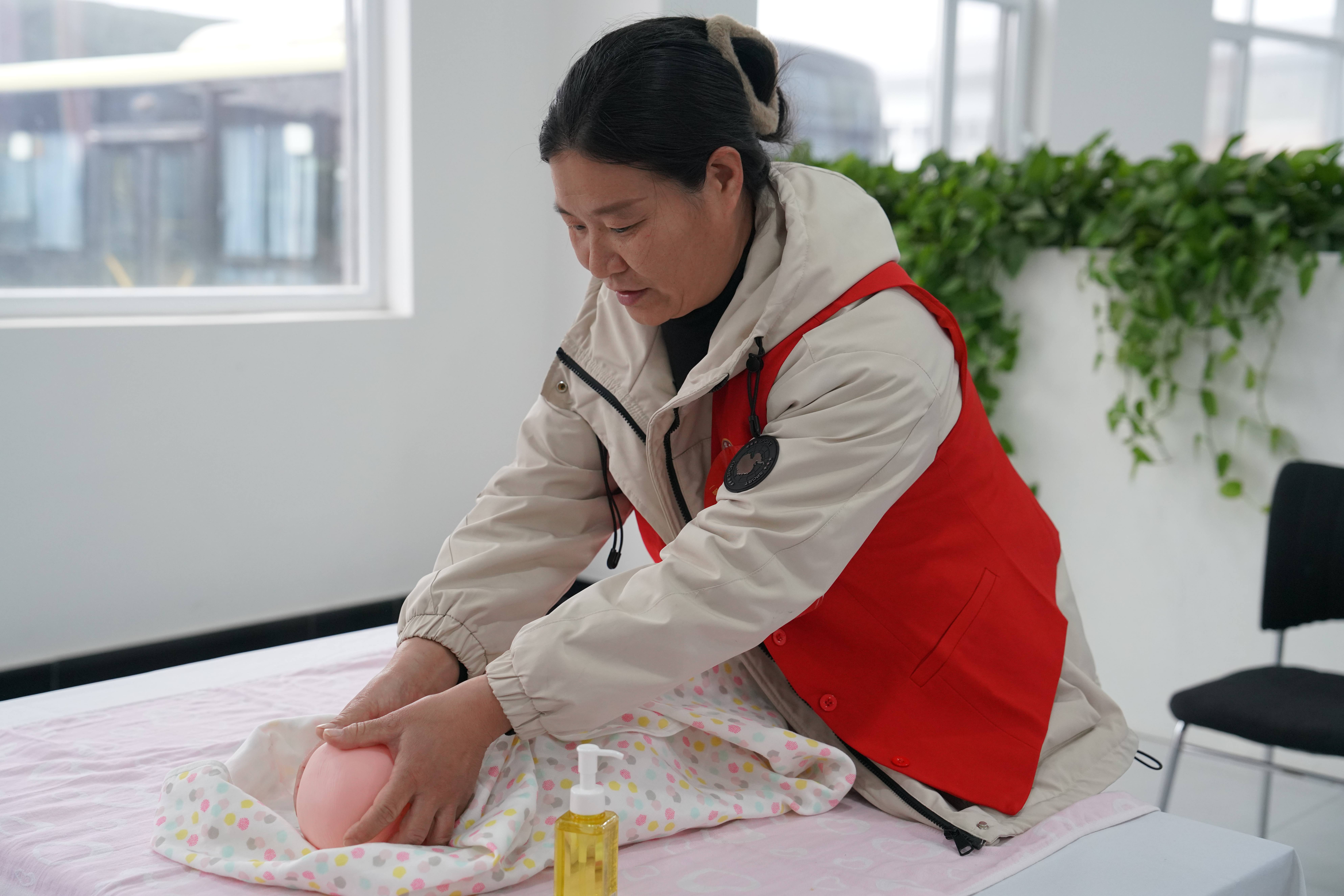 保定清苑：“河北福嫂”家政服务业（育婴员）技术操作竞赛开赛_fororder_参赛选手“新生儿抚触操”实操考核现场。摄影 王磊