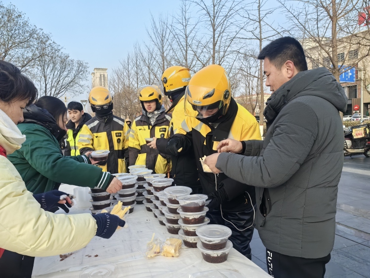 河北迁安：腊八粥香漫全城 志愿温情暖人心_fororder_在迁安市人民广场，志愿者为户劳动者送来热腾腾的腊八粥。郭强摄 (2)