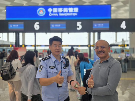 “郑”值浓情端午节 郑州边检守国门优服务护口岸稳序运转_fororder_郑州边检站民警向外籍旅客介绍端午节（王晗摄）