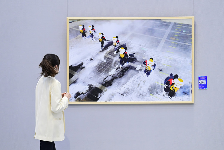 内蒙古：呼和浩特抗击疫情摄影作品展开展_fororder_（5）2022年4月29日，观众在内蒙古美术馆观赏抗击疫情摄影作品展。.JPG