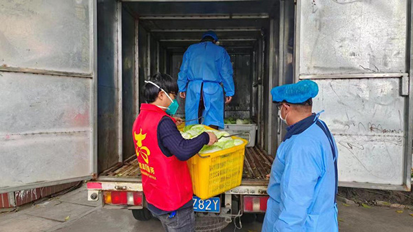 成都市新都区：爱心企业为社区捐赠2000斤蔬菜_fororder_新都区智稼家庭农场的员工正在将捐赠的蔬菜搬下车