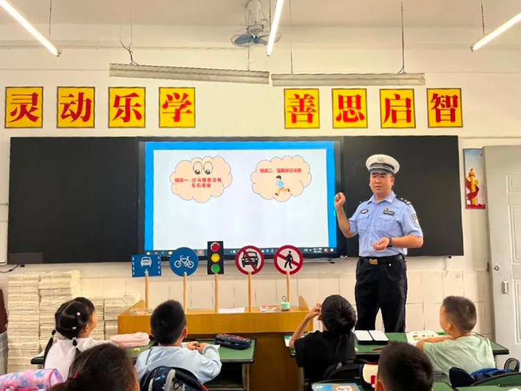 广汉公安站好“护学岗” 撑起“平安伞”_fororder_广汉交警大队民警开展开学第一课讲解1