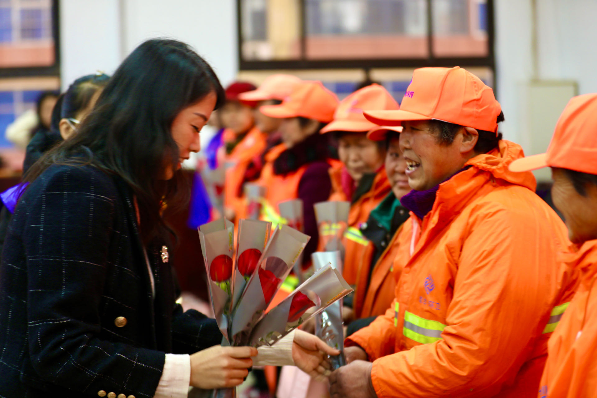 河北涞水：情暖巾帼心 爱在妇女节_fororder_图为志愿者为环卫女工发放鲜花和礼品。徐梓钰 摄