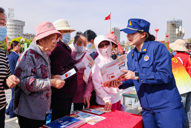 张掖市开展2025年“防灾减灾日” 主题宣传活动_fororder_消防救援大队工作人员为群众提供消防咨询