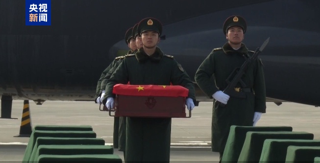 43名搬运烈士遗骸棺椁的礼兵正按序下机 对棺椁进行整理