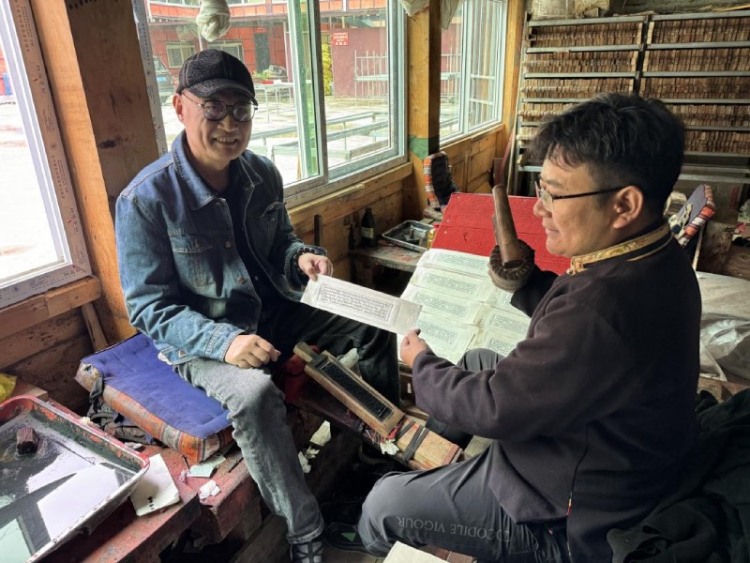 西博会启幕 甘孜文旅凭非遗与自驾路线实力“圈粉”_fororder_沈宁强体验雕版印刷  供图 甘孜州委宣传部